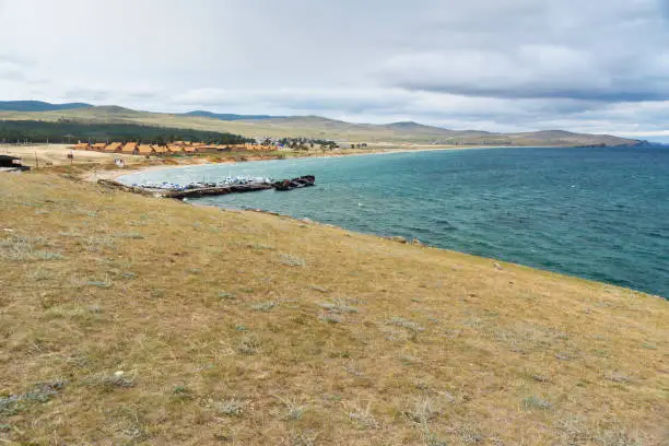 View of Pier with ships and beach in Khuzhir Village on Olkhon Island, Siberia, Russia