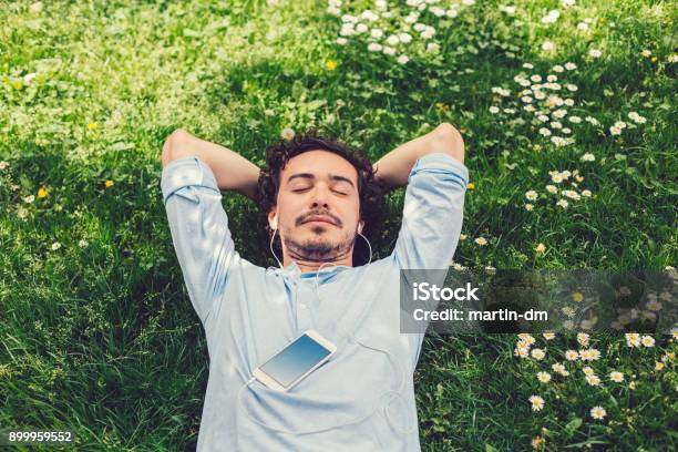Man Napping In The Grass Stock Photo - Download Image Now - Men, Relaxation, Meditating