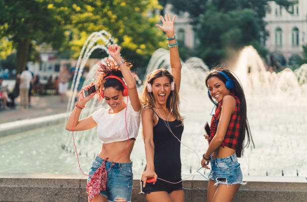 istock Girls dancing to music 899959880