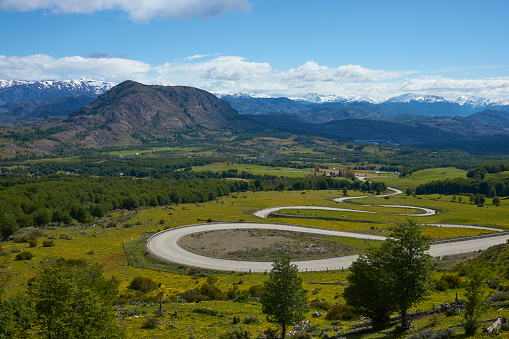 The Carretera Austral; famous road connecting remote towns and villages in northern Patagonia, Chile. Curved section running through farmland near the small town of Cerro Castillo.