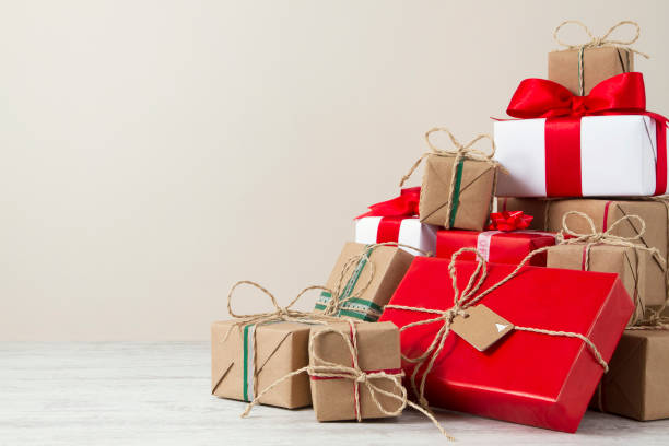 istock Christmas Gift Boxes on White Wooden Table 899960910