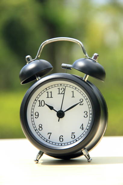 istock Alarm clock on nature background 899966836