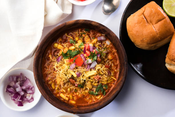 Misal Pav or misalpav, Misal Pav with Farsan. Traditional Indian spicy dish made with moth beans (match) and served with farina and bread Misal Pav or misalpav, Misal Pav with Farsan. Traditional Indian spicy dish made with moth beans (match) and served with farina and bread pune photos stock pictures, royalty-free photos & images