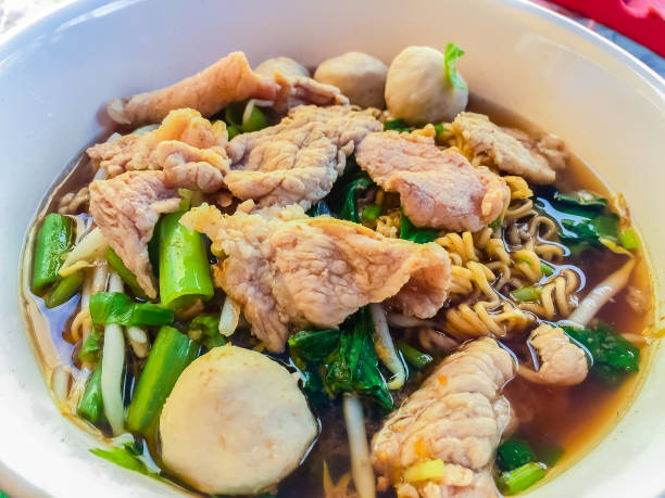 Popular street food in Thailand (Kuai Tiao Moo Namtok) that consisted of pork ball, pork meat, basil or thyme, bean sprouts, morning glory, noodle and creamy soup which favouring with sugar, fish sauce, chilli and vinegar marinade comida popular calle en tailandia (kuai tiao moo namtok) que consistía en bola del cerdo, carne de cerdo, albahaca o tomillo, brotes de soja, gloria de mañana, fideos y sopa cremosa que favorecer con el azúcar, salsa de pescado, ají y vinagre adobo