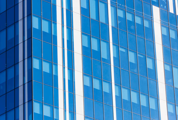 istock Clouds Reflected in Windows of Modern Office Building 899973182