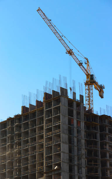 istock yellow industrial construction crane against blue sky 899973704