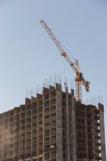 istock yellow industrial construction crane against blue sky 899973724