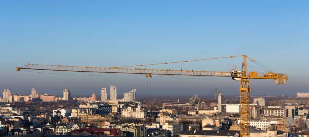 istock yellow industrial construction crane against blue sky 899976470