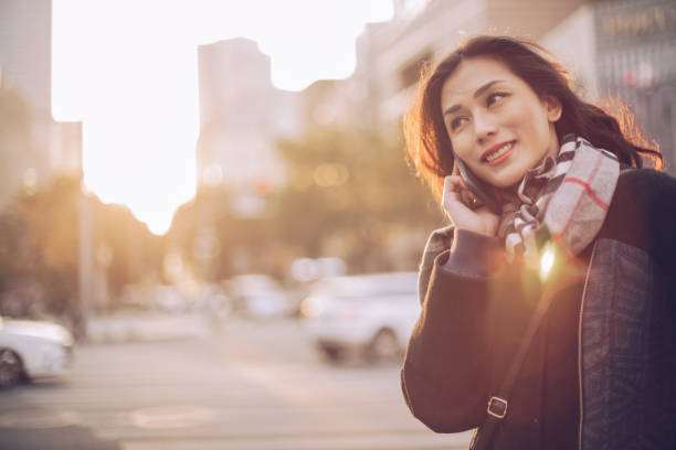 istock Woman using mobile phone on the street 899977460