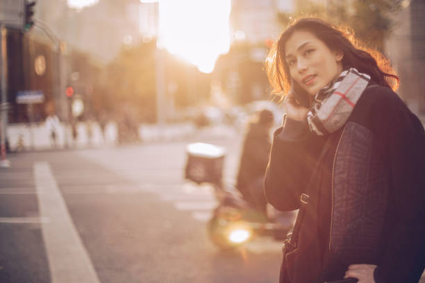 istock Young woman using phone on the street 899979728