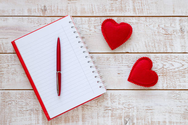 istock Valentines Day background with hearts over white wooden table 899980570