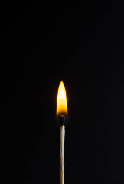 istock Photo of a burning match on a black background 899983888