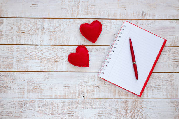 istock Valentines Day background with hearts over white wooden table 899994348