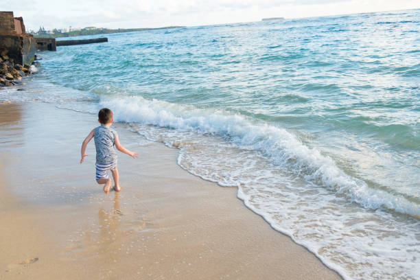 istock Child Playing on Beach in Oahu Hawaii 899994602