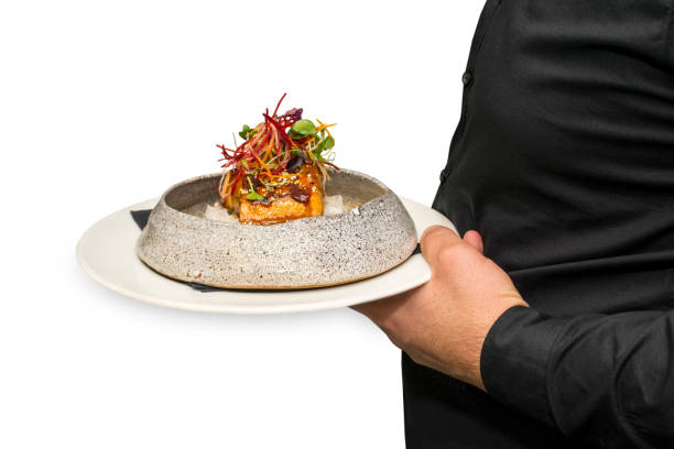 istock Chef serving Fried Salmon Steak with Teriyaki Sauce over Rice 899994778