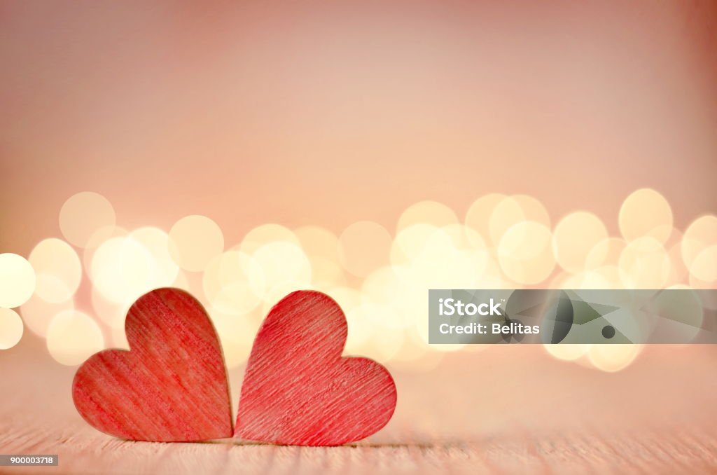 Hearts on a wooden table and background is a bokeh. Hearts on a wooden table and background is a bokeh. valentines day concept. Love - Emotion Stock Photo