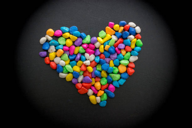 istock Colorful little pebbles form a heart shape 900020494