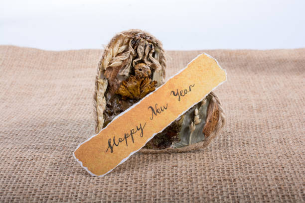 istock Happy new year written torn paper beside a heart 900020512