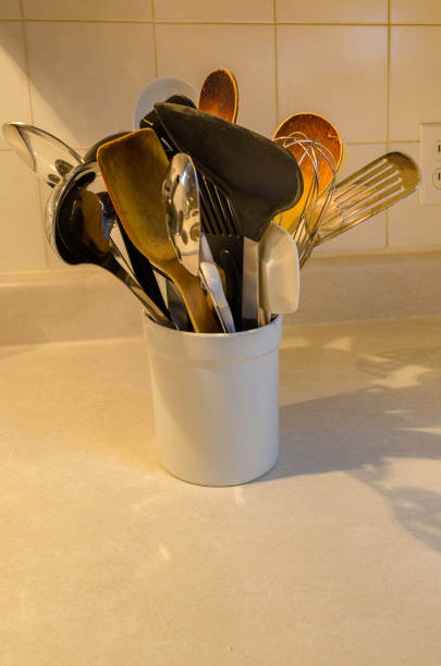 istock kitchen utensils in white ceraminc jar on countertop with ceramic tiles in the background 900020656