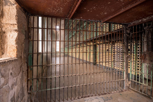 istock Jail cell corridor with painted and rusted bars 900024134