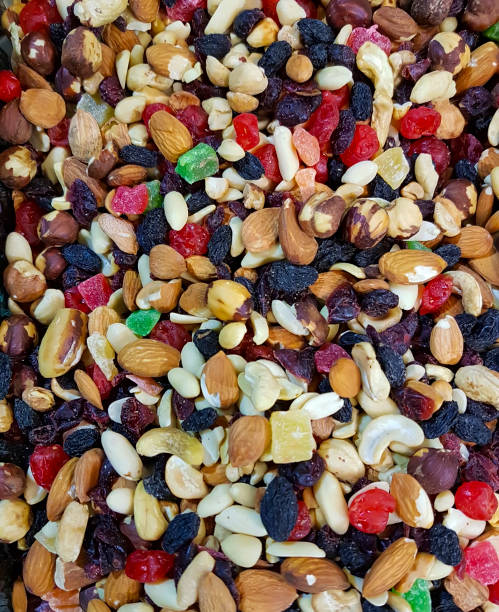 istock nuts, raisins, almonds dried fruits background 900036228