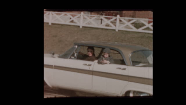 Little boy shoots toy cap gun from vintage car 1957 Plymouth Belvedere