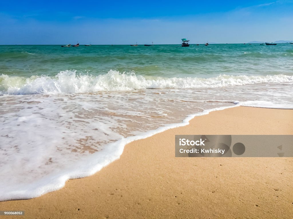 White bubbles created on the beach by ocean waves on seashore Foam bubbles abstract white background. Detergent white foam with some bubbles in it A wave thinning out of the sand of a beach Abstract Stock Photo