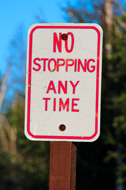 istock A red no stopping any time sign 900070948