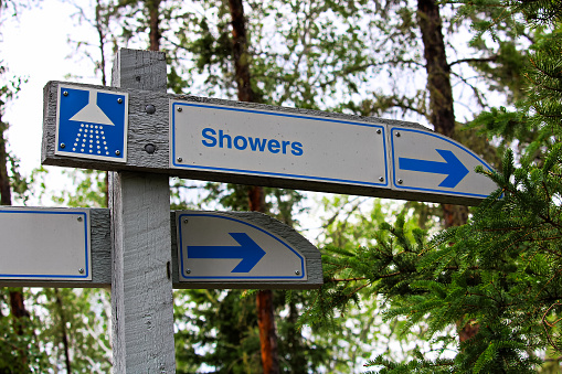 A direction sign for showers at a campground.