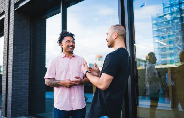 istock Two work colleagues talking outside the office building. 900078290
