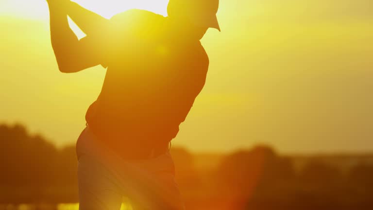 Golfer male Caucasian golf course practice smart clothes sponsorship self employment corporate competition sunset slow motion RED EPIC