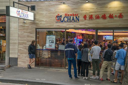 Melbourne, Australia - December 30, 2017: Customers wait in line outside Hawker Chan, a new eatery on Lonsdale Street. Hawker Chan is an offshoot of founder/chef Chan Hon Meng's hawker stall in Singapore, which has the distinction of being awarded a Michelin star.