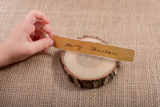 istock Merry Christmas  written on a torn paper 900097434