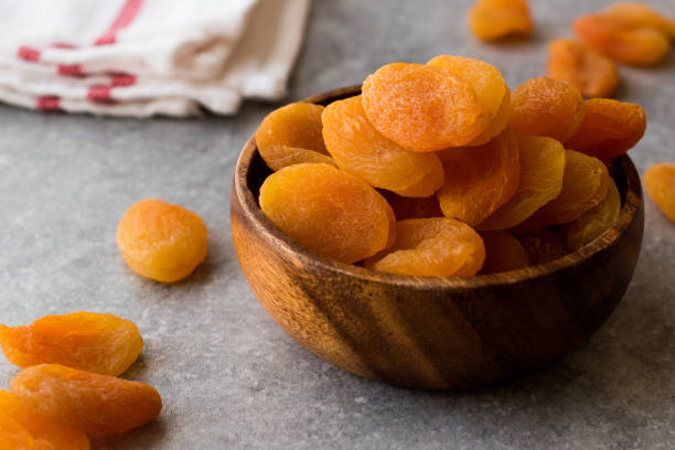 istock Dried Apricots in wooden Bowl. 900111198