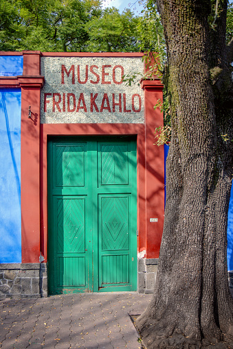 Mexico City, Mexico - December 4, 2017: The facade of Frida Kahlo’s birthplace and residence for most of her life, also known as the Blue House, which is now a museum in Coyoacan, Mexico City.