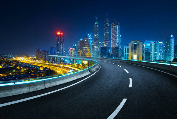 istock Blue neon light design highway overpass with modern city background . Night scene . 900114250