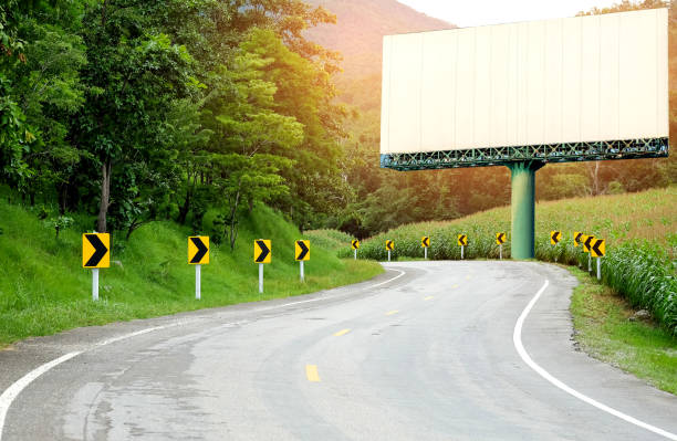 istock Asphalt road curved with big white billboard on the curve. 900117978