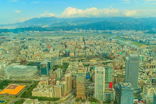Aerial panorama over Taipei, capital City of Taiwan, on a blue sky and cloudy day