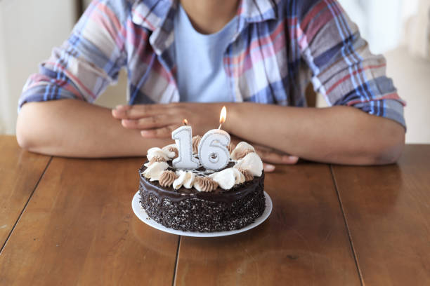 Woman holding birthday cake with candles