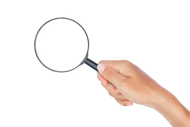 Photo of Hand with magnifying glass on white background