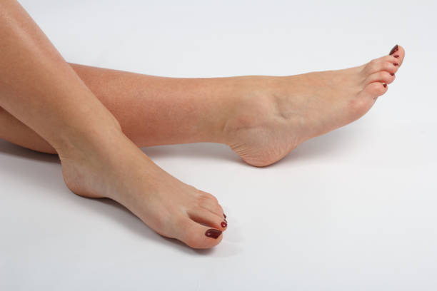 istock women's feet on a light background, pedicure 900135240
