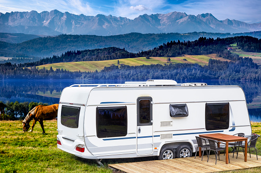 Summer scene with camper trailer by the Czorsztyn lake and Tatra Mountains landscape, Poland