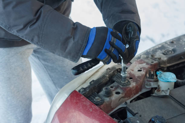 istock A man fixes a car under the hood 900145034
