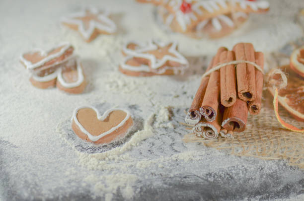 istock Cookies and Christmas cinnamon decor on wooden table. 900155712