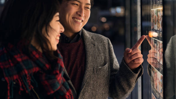 istock Young couple looking at signboard with smiling at night 900168018