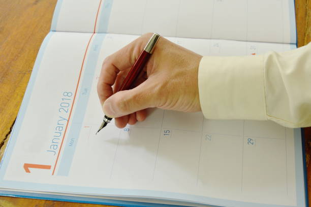 istock hand holding fountain pen write in journal book 900169064
