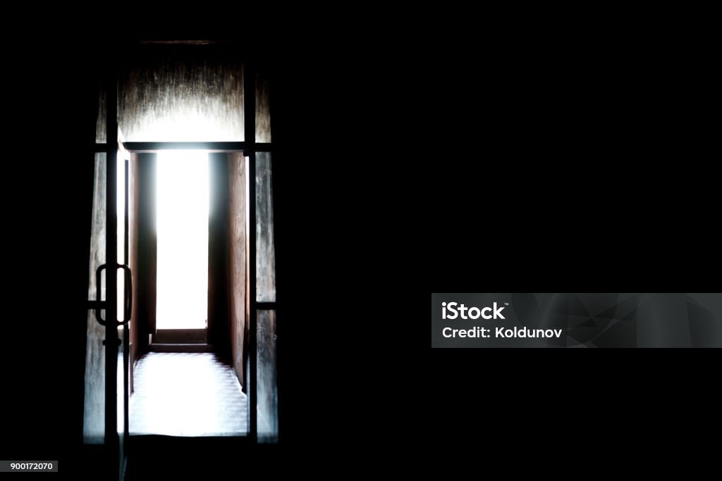 Dark room with light from the window. Concept of hopelessness and despair feeling in psychology. Dark room with light from the window. Concept of hopelessness and despair feeling in psychology. Giving a chance, Leaving Stock Photo