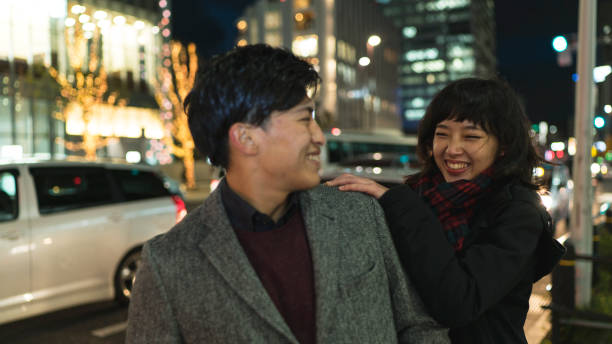 istock Young woman touching boyfriend's shoulder with smiling 900172152