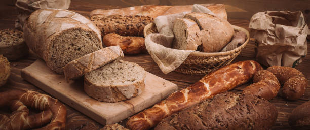 istock Various baked breads and rolls on rustic wooden table 900172820