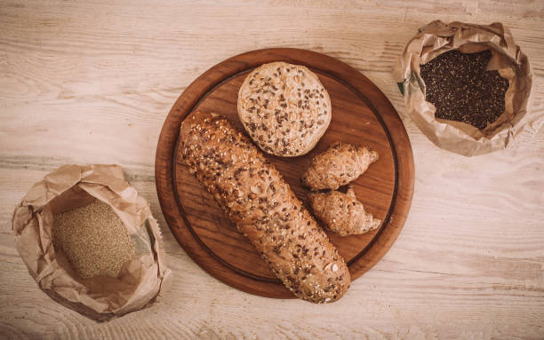 istock Many mixed baked breads and rolls on rustic wooden table 900173010